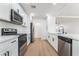 Well-lit kitchen with updated appliances, elegant countertops, and a functional layout for cooking at 343 W Basic Rd, Henderson, NV 89015