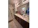 Bathroom with double sink vanity, modern fixtures, and a glass-enclosed shower at 369 Stone Fly Rd, North Las Vegas, NV 89032
