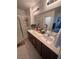 Bathroom with double sink vanity, modern fixtures, and a glass-enclosed shower at 369 Stone Fly Rd, North Las Vegas, NV 89032