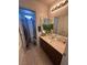 Bathroom with marble countertops, wooden cabinets, and modern fixtures, with access to the shower and toilet at 369 Stone Fly Rd, North Las Vegas, NV 89032