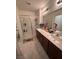 Bathroom with double sink vanity, modern fixtures, and a glass-enclosed shower at 369 Stone Fly Rd, North Las Vegas, NV 89032