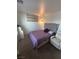 Bedroom with gray accent wall, a queen-sized bed, stylish lighting, and cozy armchair at 369 Stone Fly Rd, North Las Vegas, NV 89032