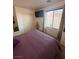 Bedroom with a large window and closet, featuring a bed, television, and neutral decor at 369 Stone Fly Rd, North Las Vegas, NV 89032