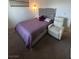 Bedroom with a queen-sized bed, stylish lighting, and comfortable armchair at 369 Stone Fly Rd, North Las Vegas, NV 89032