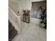 Bright foyer with marble flooring, staircase, and view of a large window at 369 Stone Fly Rd, North Las Vegas, NV 89032