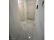 Hallway with modern white tile flooring and crisp white walls leading to other rooms at 369 Stone Fly Rd, North Las Vegas, NV 89032