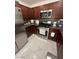 Well-equipped kitchen showcasing stainless steel appliances, granite countertops, and dark wood cabinets at 369 Stone Fly Rd, North Las Vegas, NV 89032