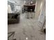 Open-concept kitchen and living room featuring bar seating and marble flooring at 369 Stone Fly Rd, North Las Vegas, NV 89032