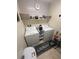 Functional laundry room with modern washer and dryer, stylish wallpaper, and organized shelving at 369 Stone Fly Rd, North Las Vegas, NV 89032