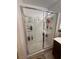 Shower stall with glass sliding doors and built-in shelving for toiletries at 369 Stone Fly Rd, North Las Vegas, NV 89032