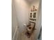Toilet with decorative accents and a storage cabinet in a half bathroom at 369 Stone Fly Rd, North Las Vegas, NV 89032