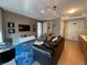 Open-concept living room featuring sleek furniture, modern lighting, and a wall-mounted TV at 3722 Las Vegas Blvd # 2709, Las Vegas, NV 89158