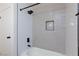 Stylish tiled shower with black fixtures and a convenient inset shelf at 3770 Shirebrook Dr # 160, Las Vegas, NV 89115