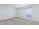 This empty bedroom features neutral carpet and two large windows for ample light at 3770 Shirebrook Dr # 160, Las Vegas, NV 89115