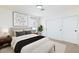 This is a staged bedroom with a large bed, bench, and abstract wall art at 3770 Shirebrook Dr # 160, Las Vegas, NV 89115