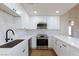 Bright kitchen features stainless steel appliances, white cabinets, and sleek countertops with a modern faucet at 3770 Shirebrook Dr # 160, Las Vegas, NV 89115