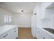 Well-lit kitchen features stainless steel appliances, an island, white cabinets, and wood-look flooring at 3770 Shirebrook Dr # 160, Las Vegas, NV 89115