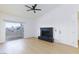 Bright living room with a black brick fireplace, ceiling fan, and sliding glass doors to a balcony at 3770 Shirebrook Dr # 160, Las Vegas, NV 89115