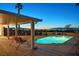 Backyard pool with a seating area, palm trees, and a view of the city skyline at 392 Waterwheel Falls Dr, Henderson, NV 89015