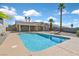 Sparkling backyard pool with a spacious patio, palm trees, and desert landscaping at 392 Waterwheel Falls Dr, Henderson, NV 89015