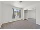 Bright bedroom with plush carpeting, large window, and a sliding-door closet for ample storage at 392 Waterwheel Falls Dr, Henderson, NV 89015