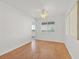 Bright bedroom featuring neutral walls, wood-look flooring and an arched doorway at 392 Waterwheel Falls Dr, Henderson, NV 89015