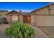 Charming single-story home featuring desert landscaping, an arched entryway, and a spacious two-car garage at 392 Waterwheel Falls Dr, Henderson, NV 89015