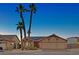 Front exterior of a single-story home with a two-car garage, desert landscaping, and solar panels at 392 Waterwheel Falls Dr, Henderson, NV 89015