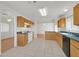 This kitchen offers wood cabinets, tile flooring and black appliances and offers an open floorplan design at 392 Waterwheel Falls Dr, Henderson, NV 89015