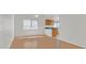 Open-concept living and dining area featuring hardwood floors, lots of natural light, and a view into the kitchen at 392 Waterwheel Falls Dr, Henderson, NV 89015
