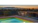 Backyard pool and patio area with outdoor dining and city views at 392 Waterwheel Falls Dr, Henderson, NV 89015