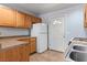 The kitchen is equipped with a white refrigerator, tiled flooring, and wooden cabinets at 4000 Visby Ln, Las Vegas, NV 89119