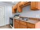 The kitchen has wooden cabinetry and a stainless steel sink with tile flooring at 4000 Visby Ln, Las Vegas, NV 89119
