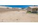 View of a spacious backyard area, ready for landscaping and outdoor activities, with block wall and blue sky at 4255 Breezy Point Ln, Las Vegas, NV 89115