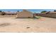 Backyard with a partially covered patio area, block fence, and space for outdoor gatherings and recreation at 4255 Breezy Point Ln, Las Vegas, NV 89115