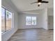Bright bedroom with wood-look flooring, a ceiling fan, and multiple windows at 4255 Breezy Point Ln, Las Vegas, NV 89115