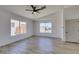 Bright bedroom features wood-look flooring, a ceiling fan, and plenty of natural light at 4255 Breezy Point Ln, Las Vegas, NV 89115