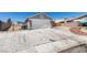 Home features an oversized driveway with ample parking space, leading to a two-car garage at 4255 Breezy Point Ln, Las Vegas, NV 89115