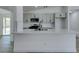 Bright kitchen features a central island, stainless appliances, and backyard access at 4255 Breezy Point Ln, Las Vegas, NV 89115