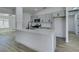 Bright kitchen boasts a large island, stainless appliances, modern cabinetry, and sleek fixtures at 4255 Breezy Point Ln, Las Vegas, NV 89115
