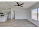 The well-lit living room has wood-look floors, a modern fan, and a large window at 4255 Breezy Point Ln, Las Vegas, NV 89115