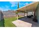 A delightful backyard featuring a covered patio, artificial turf, and ample space for outdoor entertaining at 508 Purcell Dr, Las Vegas, NV 89107