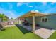 Backyard featuring a patio, dining table, play area, and artificial turf at 508 Purcell Dr, Las Vegas, NV 89107