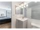 Bathroom features vanity with sink, mirror, toilet and view into the bedroom at 508 Purcell Dr, Las Vegas, NV 89107