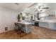 Open kitchen features stainless appliances, gray cabinets, breakfast bar and tile floor at 508 Purcell Dr, Las Vegas, NV 89107