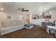 Comfortable living room features carpeted floors, a ceiling fan, and a pass-through view of the kitchen at 508 Purcell Dr, Las Vegas, NV 89107