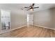 This spacious bedroom features wood floors, a ceiling fan, and bathroom at 5245 Hillman Ave, Las Vegas, NV 89142