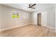This light-filled bedroom features wood floors, a ceiling fan, and closet at 5245 Hillman Ave, Las Vegas, NV 89142