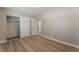Bright bedroom features neutral paint, wood-look flooring, and closet with sliding doors at 5245 Hillman Ave, Las Vegas, NV 89142