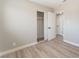Bright bedroom features neutral paint, wood-look flooring, and closet with sliding doors at 5245 Hillman Ave, Las Vegas, NV 89142
